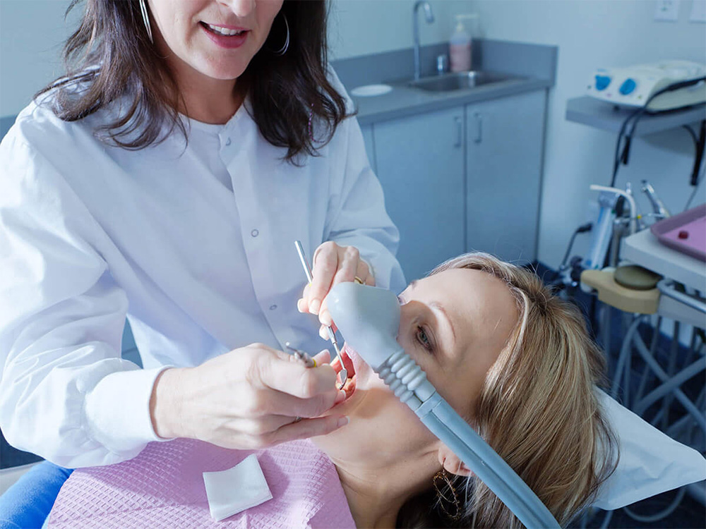 Patient receiving laughing gas sedation during a treatment